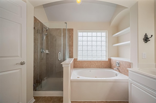 bathroom with a stall shower, tile patterned floors, vanity, and a bath