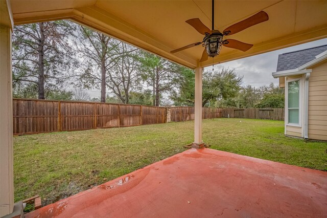 view of yard with a fenced backyard, a ceiling fan, and a patio