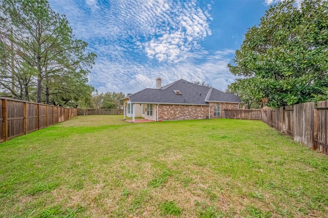 view of yard featuring a fenced backyard