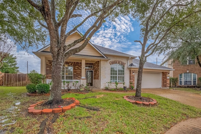 single story home featuring brick siding, covered porch, an attached garage, fence, and driveway