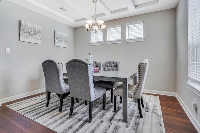 dining space with visible vents, a notable chandelier, baseboards, and wood finished floors