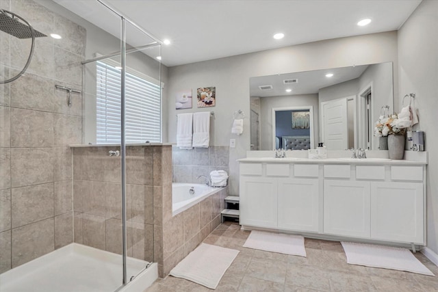 bathroom featuring double vanity, a stall shower, visible vents, a garden tub, and recessed lighting