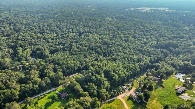 drone / aerial view featuring a view of trees