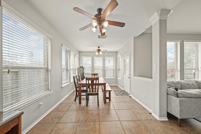 dining space featuring light tile patterned floors, baseboards, visible vents, and a wealth of natural light