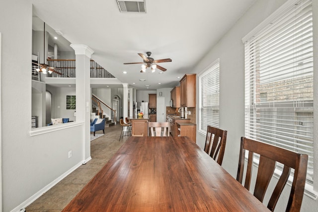 dining area featuring ornate columns, plenty of natural light, visible vents, and a ceiling fan