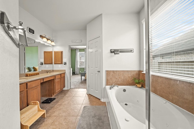 full bath featuring tile patterned flooring, a tub with jets, and vanity