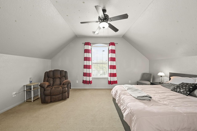 bedroom featuring baseboards, a ceiling fan, vaulted ceiling, a textured ceiling, and carpet flooring