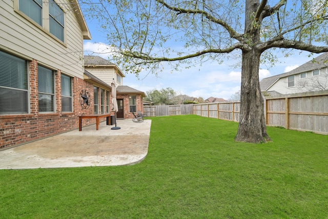 view of yard with a patio area and a fenced backyard