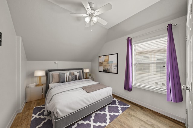 bedroom featuring vaulted ceiling, ceiling fan, wood finished floors, and baseboards