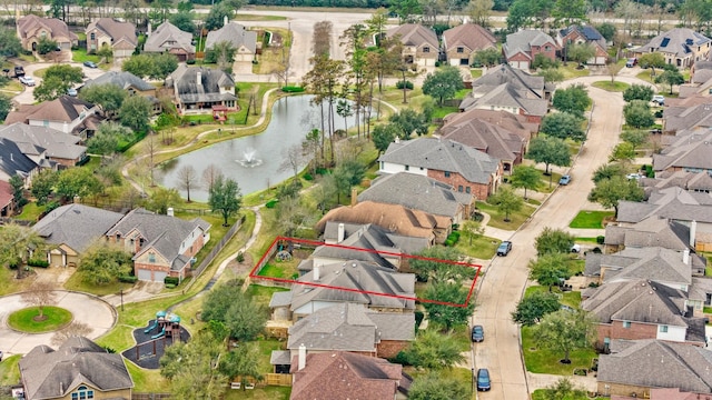 birds eye view of property with a water view and a residential view