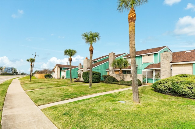 view of property's community featuring a lawn