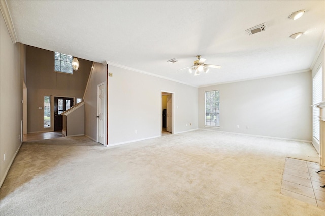 unfurnished living room with ceiling fan, carpet, visible vents, and crown molding