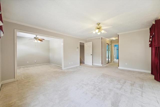 empty room with a ceiling fan, light colored carpet, ornamental molding, and baseboards