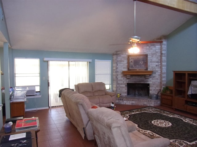 living room featuring lofted ceiling, ceiling fan, tile patterned flooring, a fireplace, and baseboards