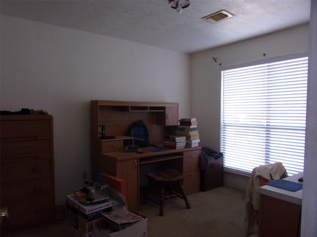 office with light carpet, a textured ceiling, and visible vents