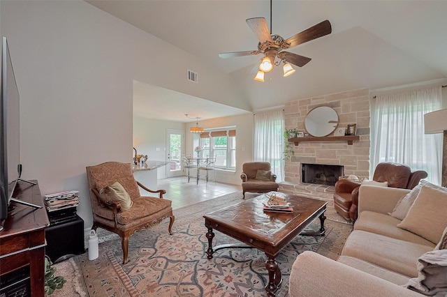 1234 Bergman Ct, Conroe, TX 77384 - living room with a ceiling fan, a stone fireplace, and vaulted ceiling