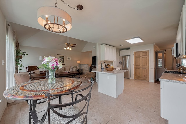 1234 Bergman Ct, Conroe, TX 77384 - dining area with a chandelier, ceiling fan, light tile patterned flooring, and vaulted ceiling