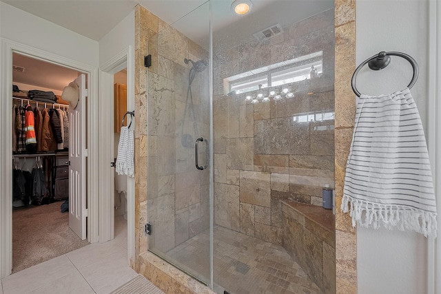 1234 Bergman Ct, Conroe, TX 77384 - bathroom with a shower stall, a spacious closet, and tile patterned floors