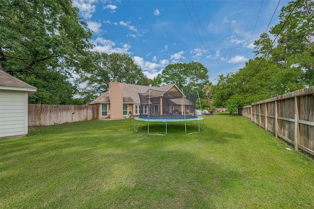 1234 Bergman Ct, Conroe, TX 77384 - back of house featuring a trampoline, a chimney, and a fenced backyard