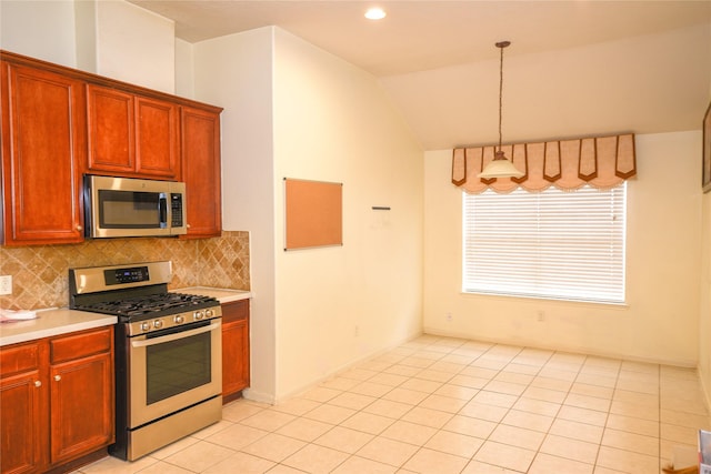 kitchen featuring stainless steel appliances, light countertops, and tasteful backsplash