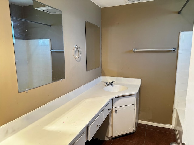 full bathroom with vanity, baseboards, and tile patterned floors