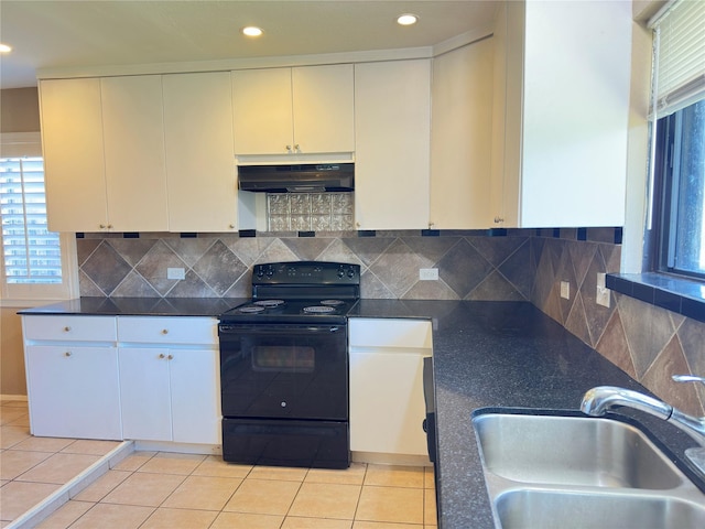 kitchen featuring decorative backsplash, under cabinet range hood, black range with electric cooktop, a sink, and light tile patterned flooring