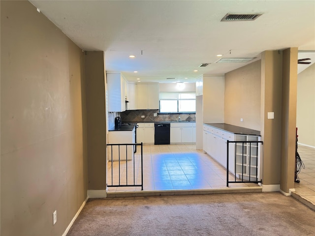 kitchen with visible vents, white cabinets, dishwasher, dark countertops, and backsplash