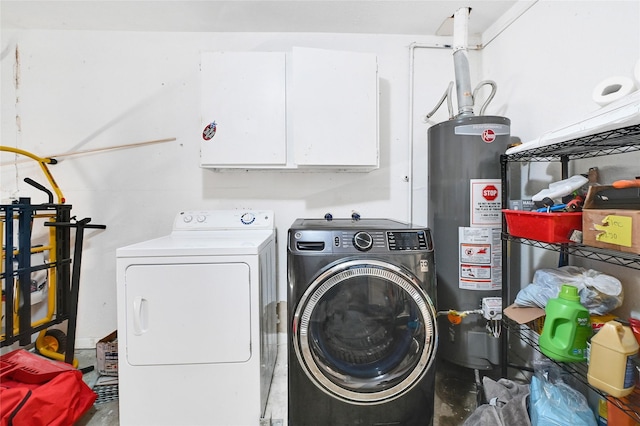 clothes washing area with washing machine and dryer and gas water heater