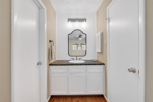 bathroom featuring vanity, a textured ceiling, and wood finished floors