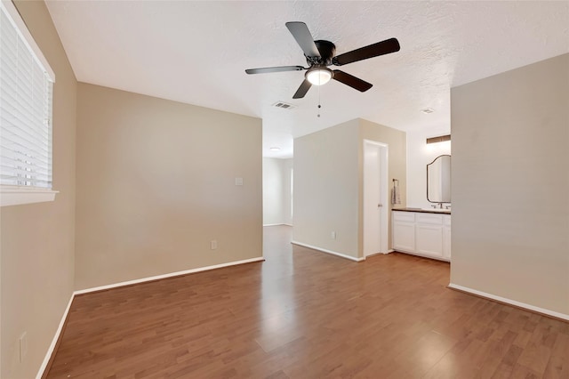 unfurnished room with visible vents, baseboards, a textured ceiling, and light wood finished floors