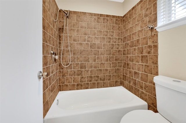 bathroom featuring toilet and  shower combination