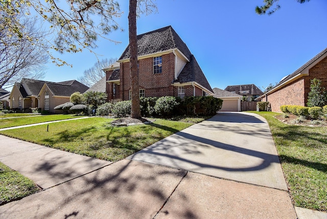 view of front of home featuring mansard roof, brick siding, a garage, and a front lawn