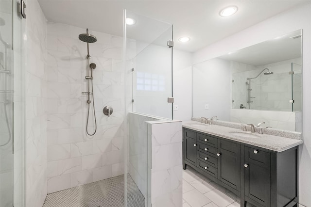 full bathroom featuring double vanity, recessed lighting, a stall shower, and a sink