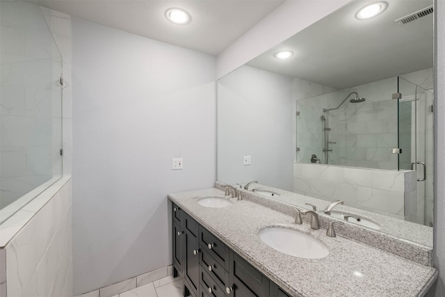 bathroom with visible vents, marble finish floor, and a sink