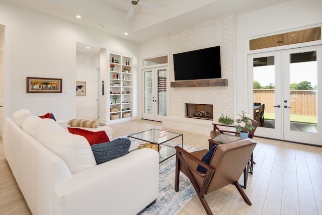 living area featuring french doors, built in shelves, and recessed lighting