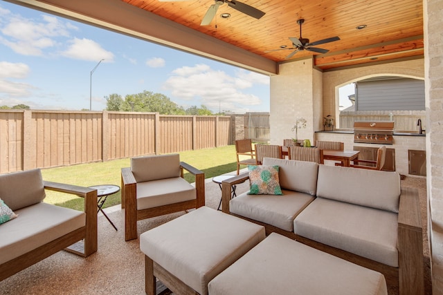 view of patio / terrace with outdoor lounge area, grilling area, a sink, exterior kitchen, and a fenced backyard