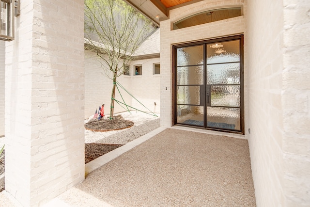 doorway to property featuring brick siding