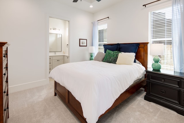 bedroom with ensuite bathroom, recessed lighting, light carpet, a ceiling fan, and baseboards