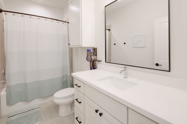 bathroom featuring shower / bathtub combination with curtain, vanity, and toilet