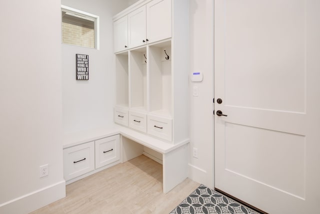 mudroom with light wood-style flooring and baseboards