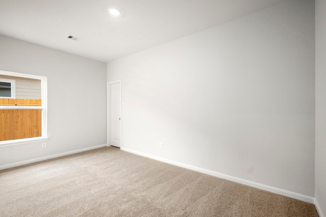 spare room featuring carpet floors, baseboards, visible vents, and recessed lighting