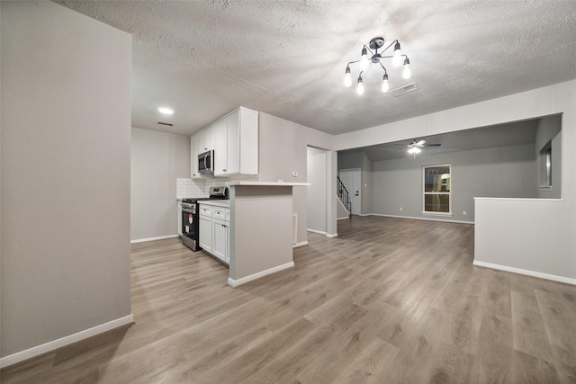 kitchen with stainless steel appliances, white cabinets, and light wood finished floors