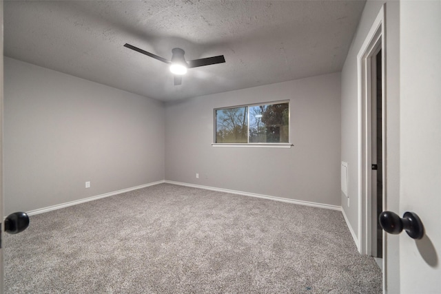 unfurnished room featuring ceiling fan, a textured ceiling, baseboards, and carpet flooring