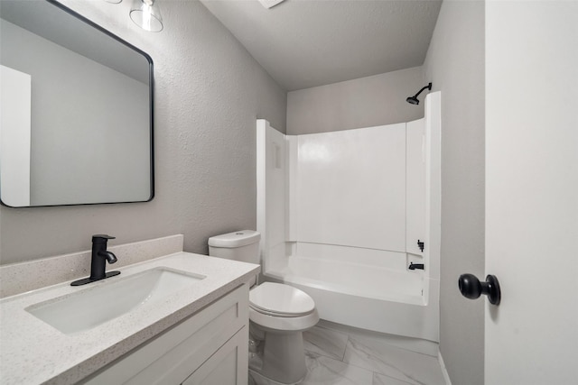 bathroom featuring a textured ceiling, toilet, bathing tub / shower combination, vanity, and marble finish floor