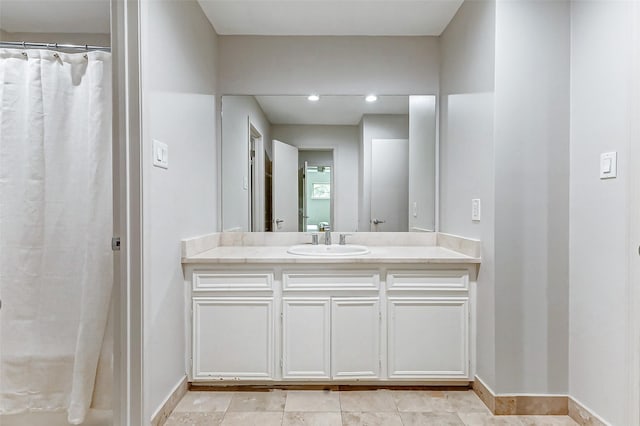 bathroom with vanity and baseboards