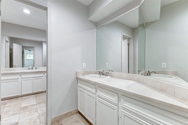 full bathroom with tile patterned floors, a sink, and double vanity