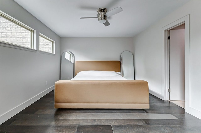 bedroom with a ceiling fan, dark wood finished floors, and baseboards