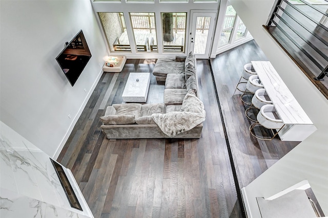 living room with wood-type flooring and baseboards