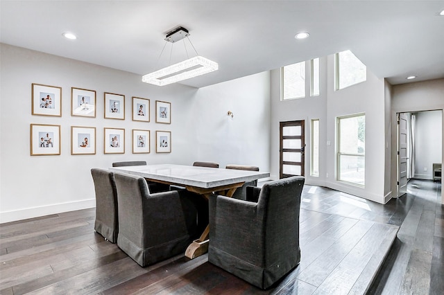 dining area featuring baseboards, dark wood finished floors, and recessed lighting