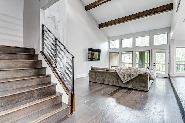 living area featuring high vaulted ceiling, hardwood / wood-style flooring, baseboards, stairway, and beamed ceiling